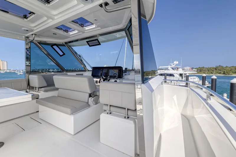  Yacht Photos Pics Interior view of 2023 Aquila 54 Yacht with modern seating and navigation equipment.