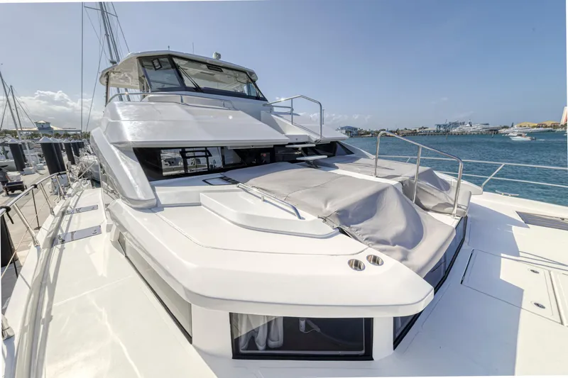  Yacht Photos Pics 2023 Aquila 54 Yacht docked, showcasing sleek design and spacious deck.
