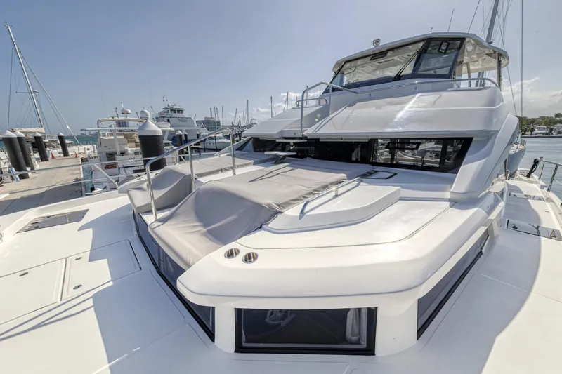  Yacht Photos Pics 2023 Aquila 54 Yacht docked at marina, showcasing sleek design and spacious deck.