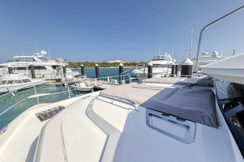  Yacht Photos Pics Aquila 54 Yacht 2023 docked at marina with clear blue sky.