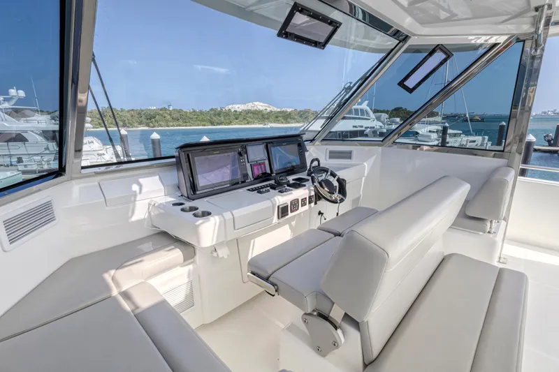  Yacht Photos Pics 2023 Aquila 54 Yacht cockpit with modern navigation equipment and luxurious seating.