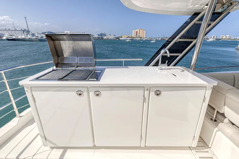  Yacht Photos Pics Outdoor kitchen on 2023 Aquila 54 Yacht with grill and sink, overlooking marina.