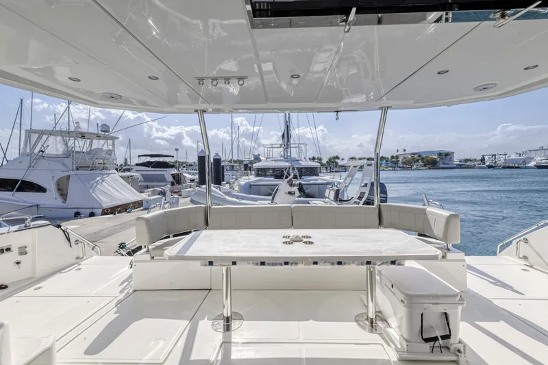  Yacht Photos Pics Aquila 54 Yacht 2023, spacious deck view, docked at marina with other boats.