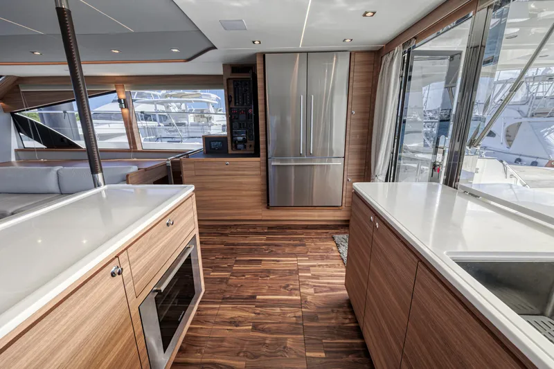 Yacht Photos Pics Luxurious interior of 2023 Aquila 54 Yacht with modern kitchen and sleek wood finishes.