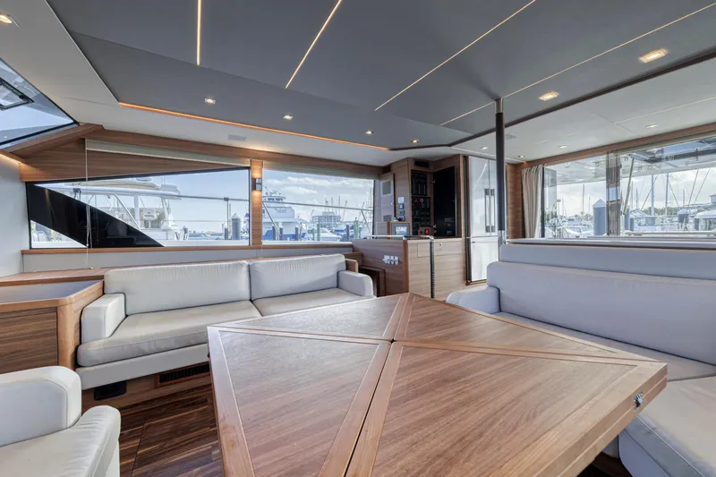 Yacht Photos Pics Luxurious interior of 2023 Aquila 54 Yacht with elegant seating and wooden table.