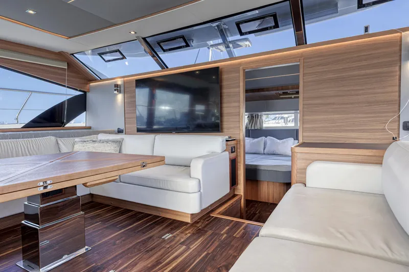  Yacht Photos Pics Luxurious interior of 2023 Aquila 54 Yacht with modern seating and large TV.