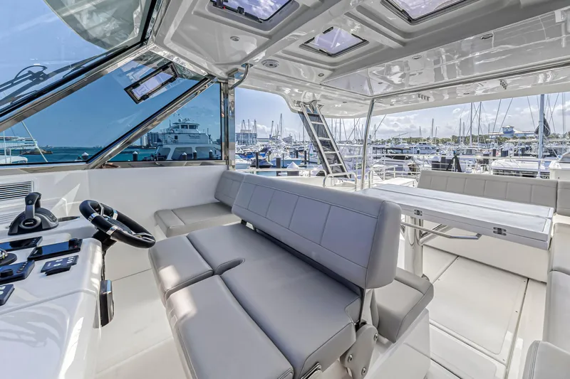  Yacht Photos Pics Interior view of 2023 Aquila 54 Yacht with modern seating and helm station.