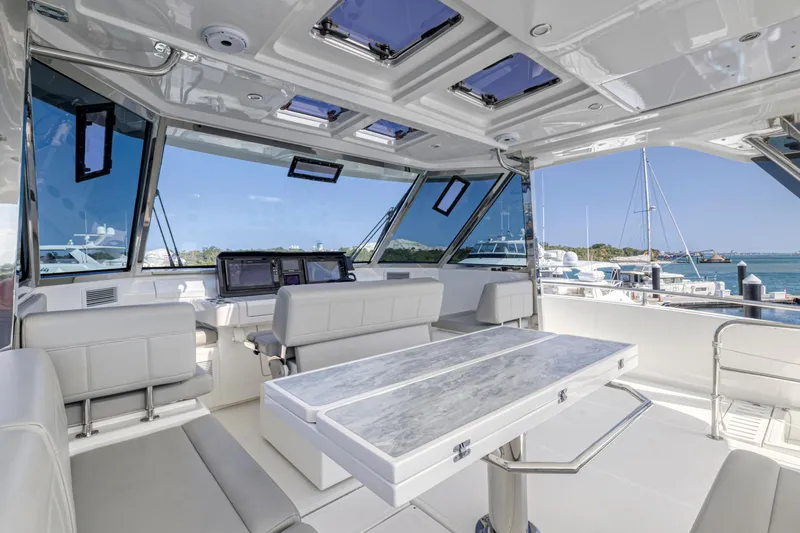  Yacht Photos Pics Luxurious interior of 2023 Aquila 54 Yacht with modern seating and panoramic windows.