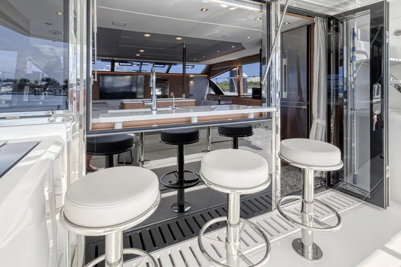  Yacht Photos Pics 2023 Aquila 54 Yacht interior with sleek bar stools and modern kitchen design.