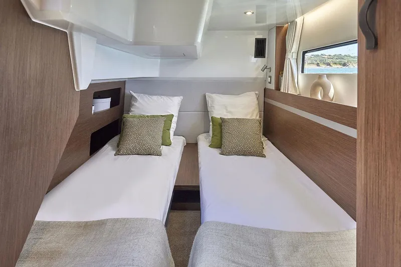  Yacht Photos Pics Manufacturer Provided Image: Luxurious cabin interior of 2026 Beneteau Antares 12 Coupe with twin beds and modern decor.