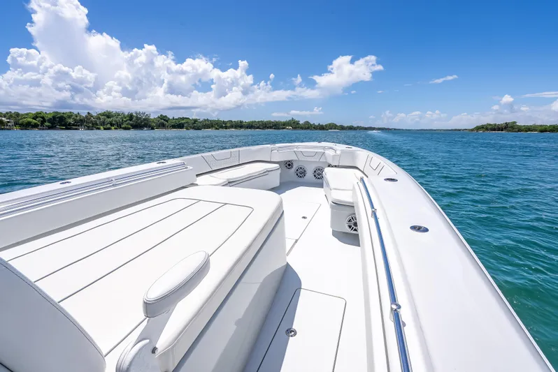 Clean Trade-ins Accepted - Bring Offers Yacht Photos Pics 2021 Contender 44 CB boat on clear blue water under a sunny sky.