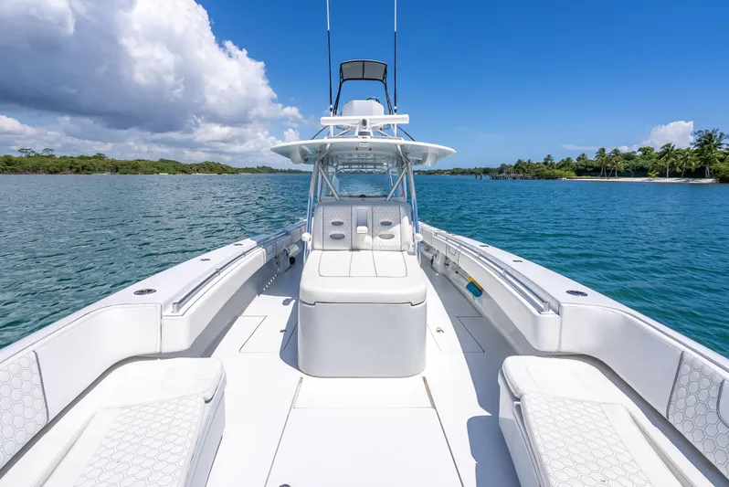 Clean Trade-ins Accepted - Bring Offers Yacht Photos Pics 2021 Contender 44 CB boat on clear blue water under a sunny sky.