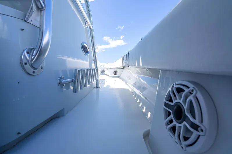 Clean Trade-ins Accepted - Bring Offers Yacht Photos Pics 2021 Contender 44 CB boat deck with speaker, stainless steel railing, and clear blue sky.