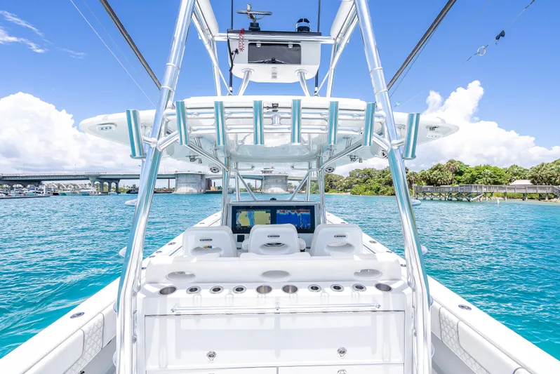 Clean Trade-ins Accepted - Bring Offers Yacht Photos Pics 2021 Contender 44 CB boat on clear blue water, featuring advanced navigation equipment.