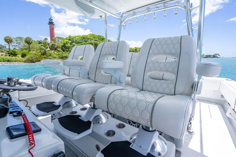 Clean Trade-ins Accepted - Bring Offers Yacht Photos Pics Contender 44 CB 2021 boat interior with luxurious seating, ocean view, and lighthouse in background.