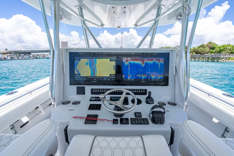 Clean Trade-ins Accepted - Bring Offers Yacht Photos Pics 2021 Contender 44 CB boat dashboard with navigation screens and controls on open water.