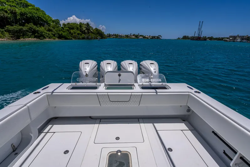 Clean Trade-ins Accepted - Bring Offers Yacht Photos Pics Contender 44 CB 2021 boat with four engines on a clear blue sea.