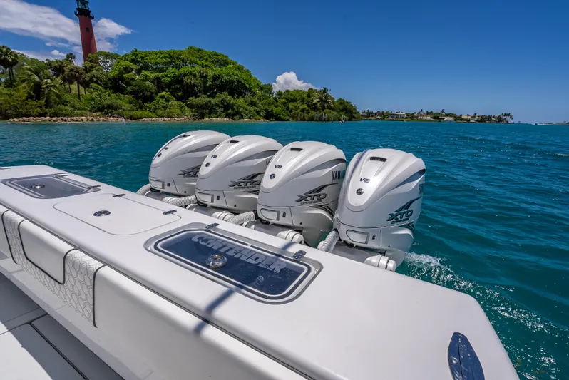 Clean Trade-ins Accepted - Bring Offers Yacht Photos Pics Contender 44 CB 2021 boat with four powerful outboard engines on blue water.