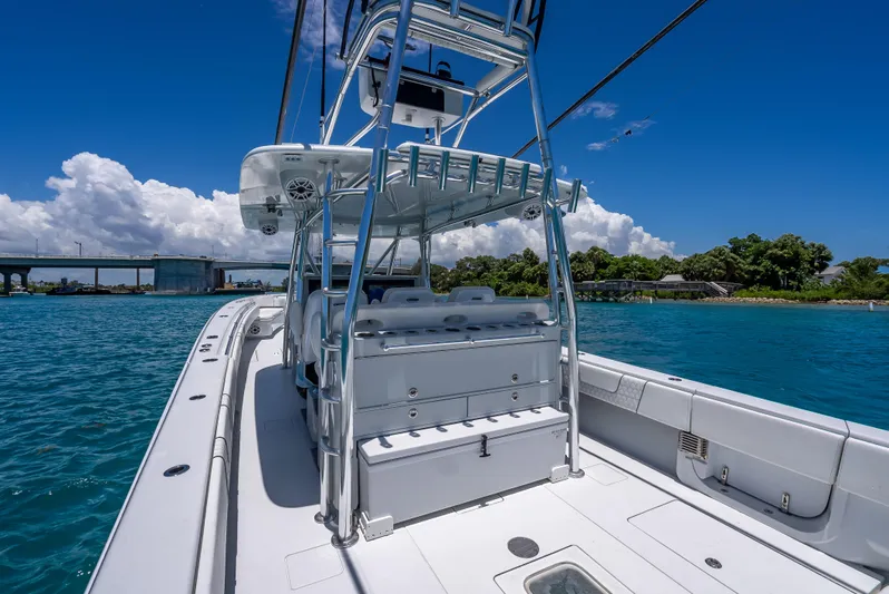Clean Trade-ins Accepted - Bring Offers Yacht Photos Pics 2021 Contender 44 CB boat on clear blue water under a sunny sky.
