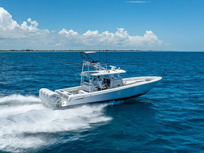 Clean Trade-ins Accepted - Bring Offers Yacht Photos Pics 2021 Contender 44 CB boat cruising on open ocean under clear blue sky.