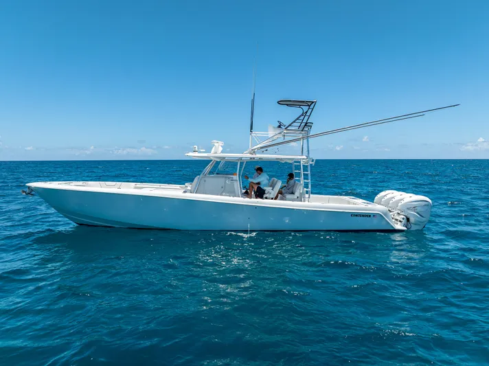 Clean Trade-ins Accepted - Bring Offers Yacht Photos Pics 2021 Contender 44 CB boat on open ocean under clear blue sky.