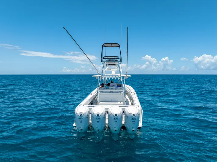 Clean Trade-ins Accepted - Bring Offers Yacht Photos Pics 2021 Contender 44 CB boat with four engines on open ocean under clear blue sky.