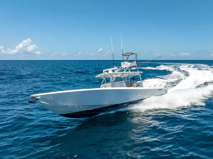 Clean Trade-ins Accepted - Bring Offers Yacht Photos Pics 2021 Contender 44 CB boat cruising on open ocean under clear blue sky.