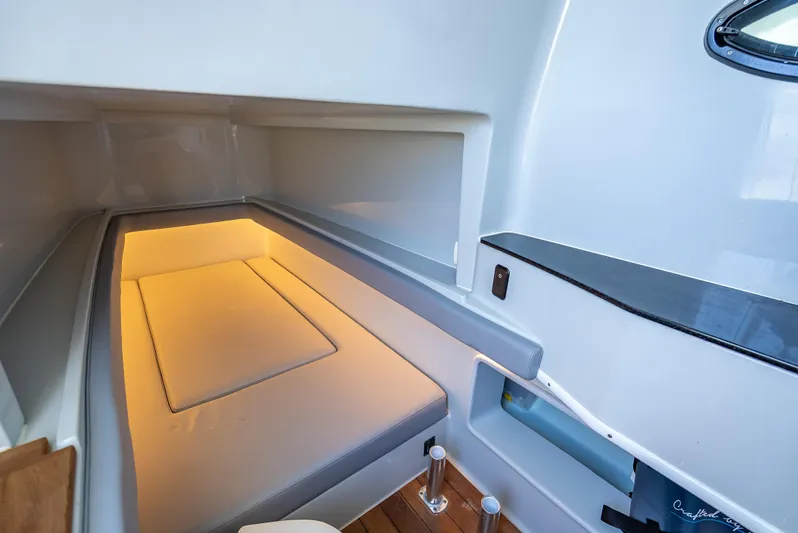 Clean Trade-ins Accepted - Bring Offers Yacht Photos Pics Interior cabin of 2021 Contender 44 CB boat with cozy lighting and modern design.