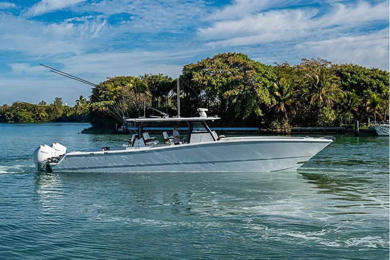  Yacht Photos Pics 2023 Freeman 47 boat cruising on a scenic waterway with lush greenery.
