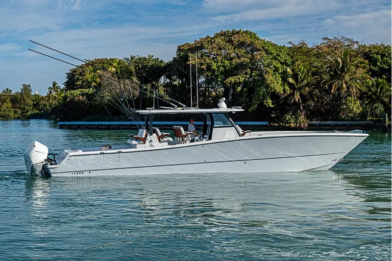  Yacht Photos Pics 2023 Freeman 47 boat cruising on a serene waterway with lush greenery.