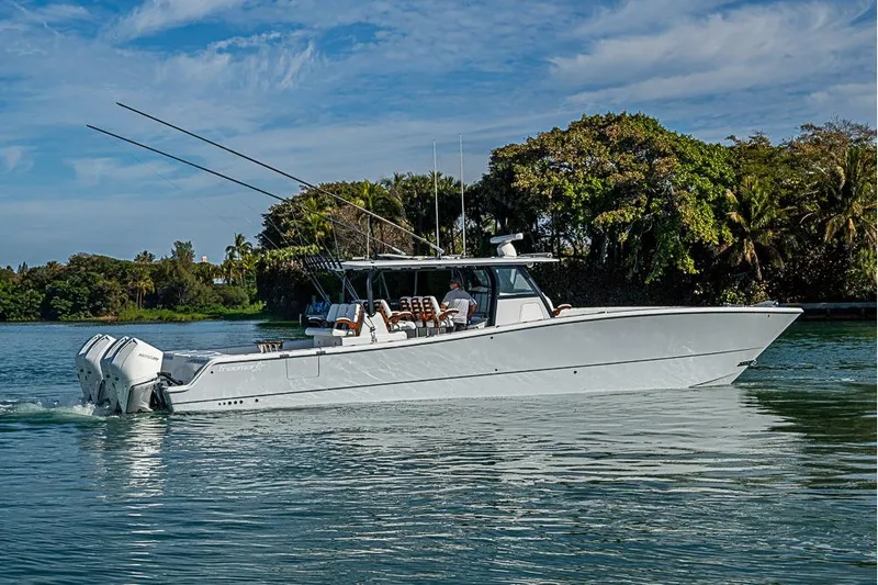  Yacht Photos Pics 2023 Freeman 47 boat cruising on a serene waterway with lush greenery.