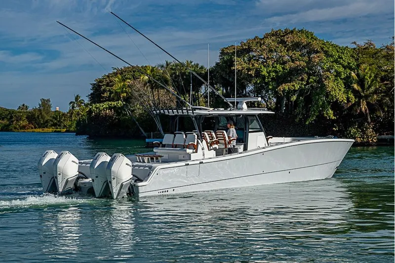  Yacht Photos Pics 2023 Freeman 47 boat cruising on a serene waterway with lush greenery.