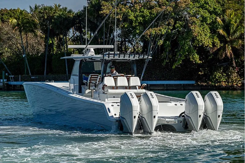  Yacht Photos Pics 2023 Freeman 47 boat with four engines cruising on a scenic waterway.