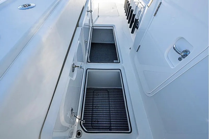  Yacht Photos Pics 2023 Freeman 47 boat deck with storage compartments and rod holders.