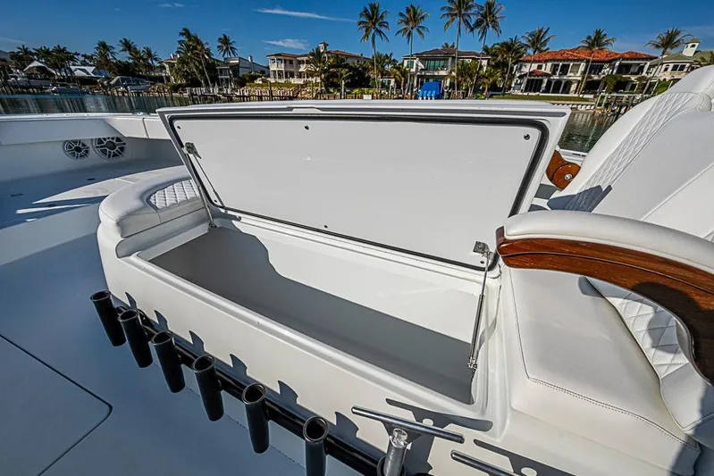  Yacht Photos Pics Open storage compartment on 2023 Freeman 47 boat with rod holders and luxurious seating.