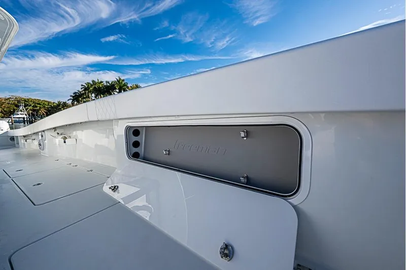  Yacht Photos Pics 2023 Freeman 47 boat deck with storage compartment under a clear blue sky.