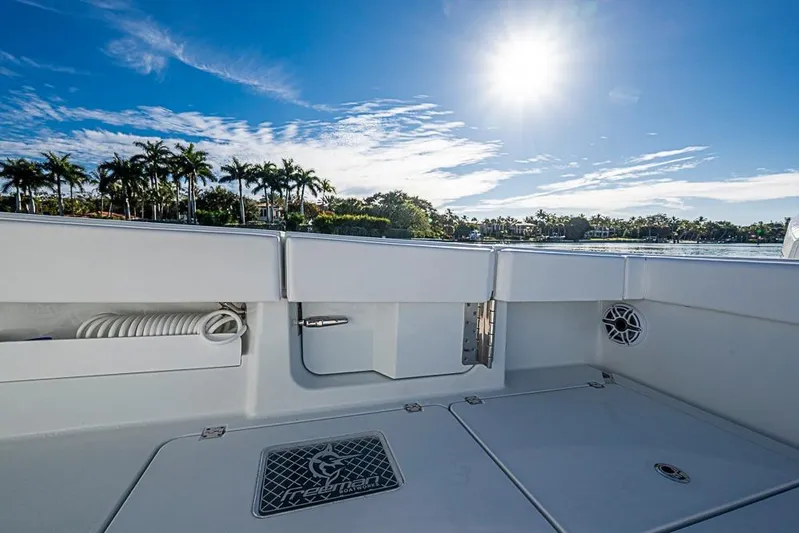  Yacht Photos Pics 2023 Freeman 47 boat deck with sunny sky and palm trees in the background.