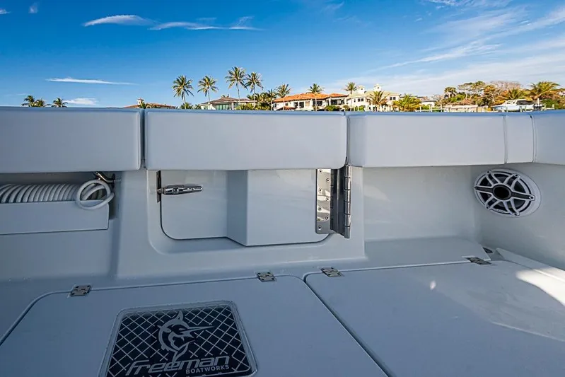  Yacht Photos Pics 2023 Freeman 47 boat interior with sleek design, palm trees, and blue sky background.