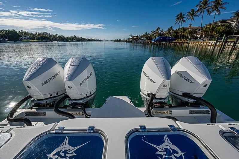  Yacht Photos Pics Four Mercury outboard engines on a 2023 Freeman 47 boat, cruising in a scenic waterway.