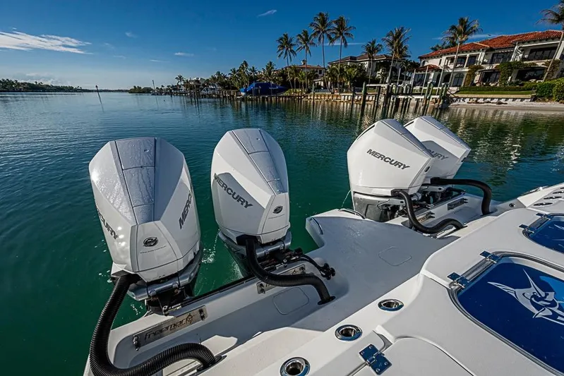  Yacht Photos Pics 2023 Freeman 47 boat with Mercury engines on a serene waterfront.