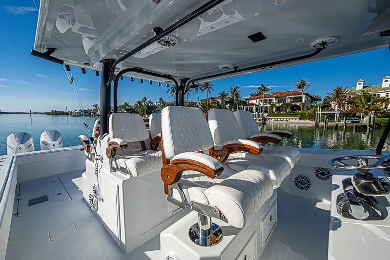  Yacht Photos Pics Luxury seating on 2023 Freeman 47 boat, with scenic waterfront view.