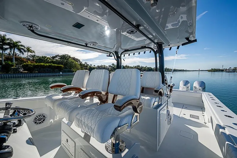  Yacht Photos Pics Luxurious 2023 Freeman 47 boat interior with plush seating and scenic waterfront view.