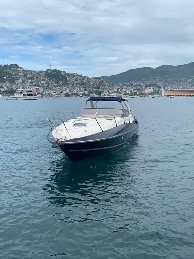  Yacht Photos Pics 1999 Sunseeker Superhawk 34 yacht on calm waters with scenic background.