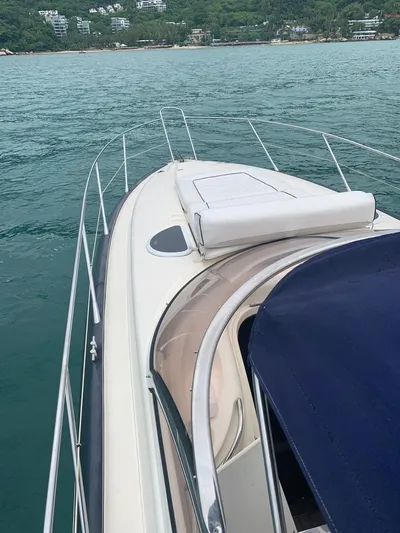  Yacht Photos Pics 1999 Sunseeker Superhawk 34 yacht cruising on calm waters.