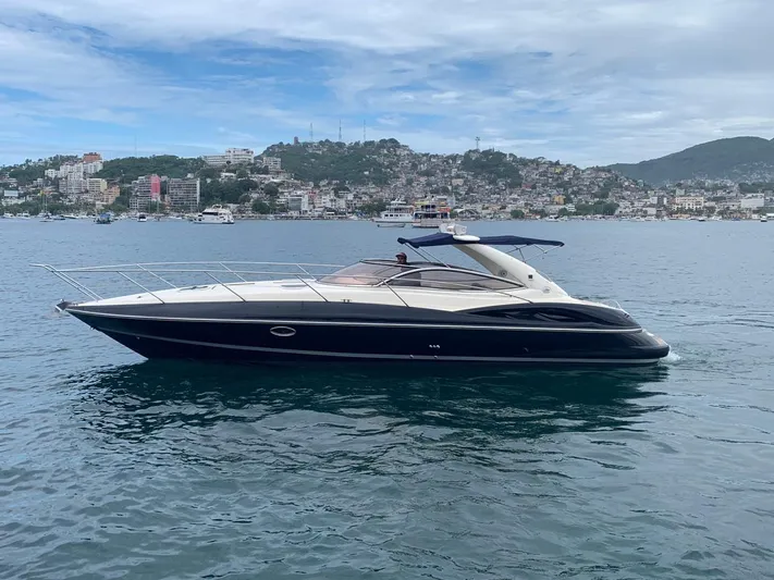  Yacht Photos Pics 1999 Sunseeker Superhawk 34 yacht cruising on a scenic coastal waterway.