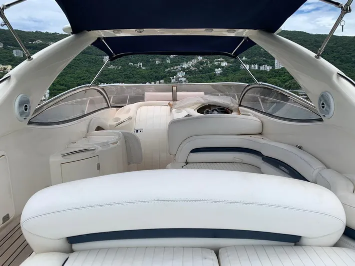  Yacht Photos Pics 1999 Sunseeker Superhawk 34 yacht interior with white seating and canopy.