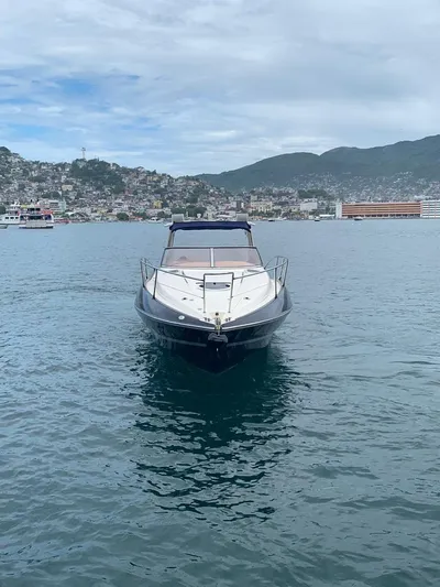  Yacht Photos Pics 1999 Sunseeker Superhawk 34 yacht on calm waters with scenic coastal backdrop.