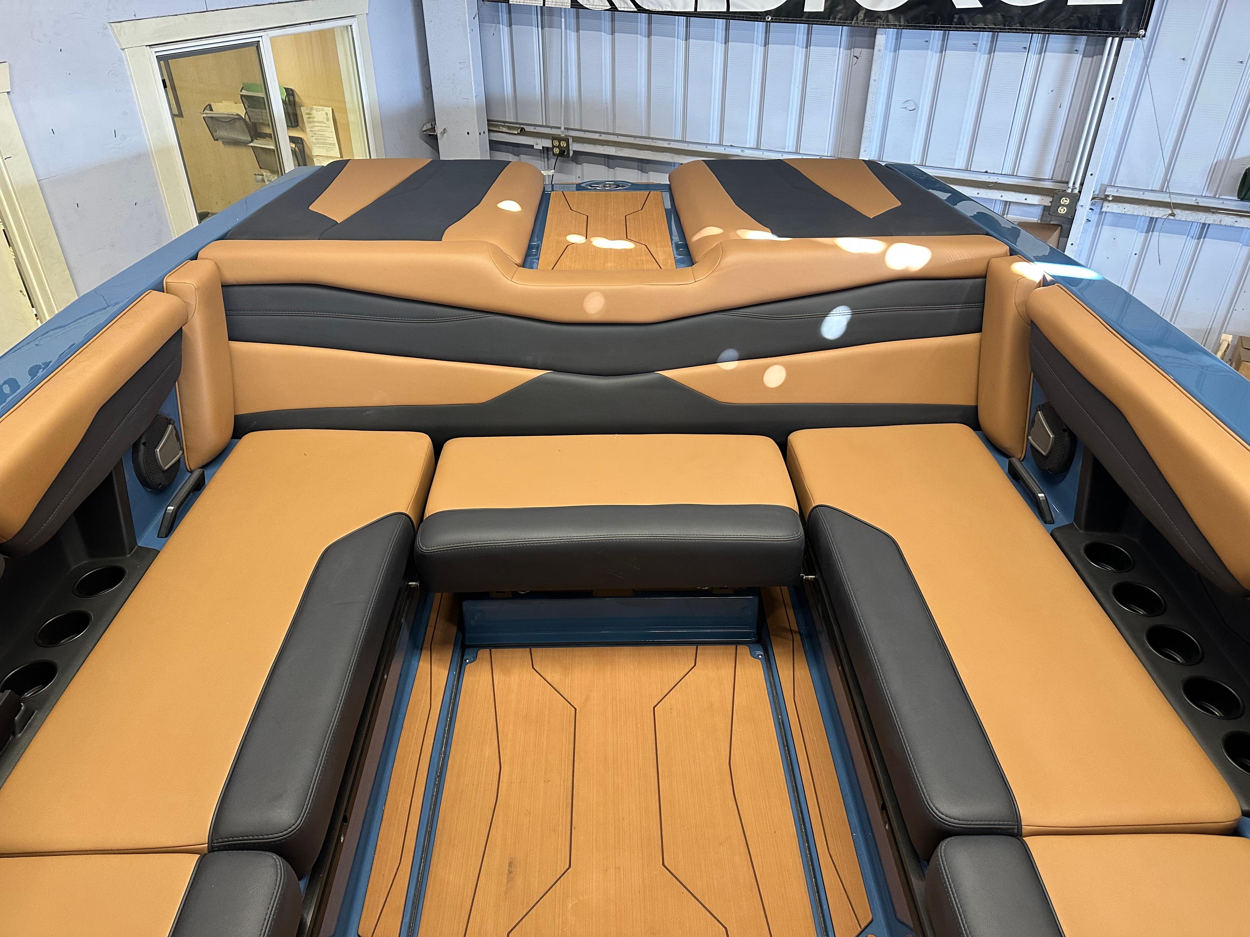 2025 Axis A245 boat interior with tan and black seating, showcasing modern design.