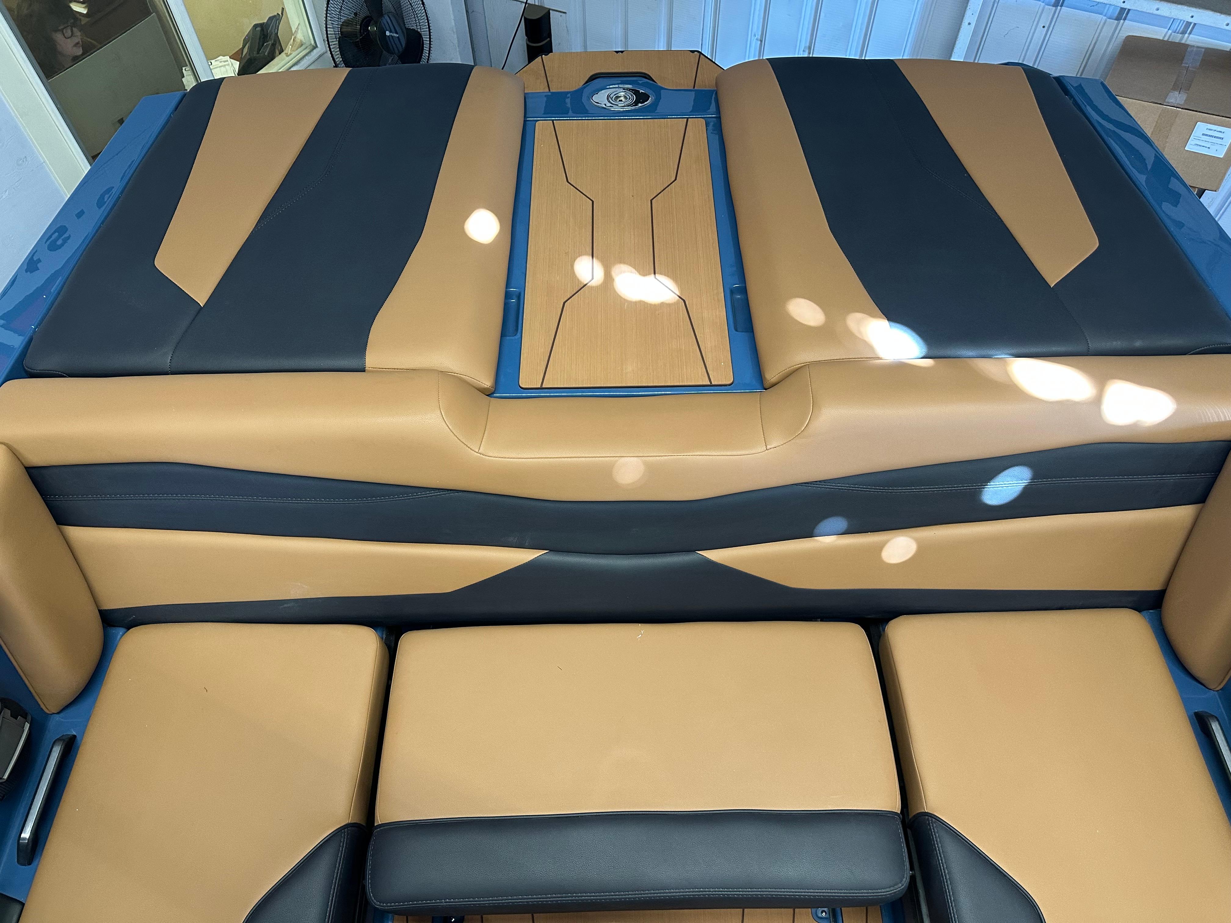 2025 Axis A245 boat interior with tan and black seating design.
