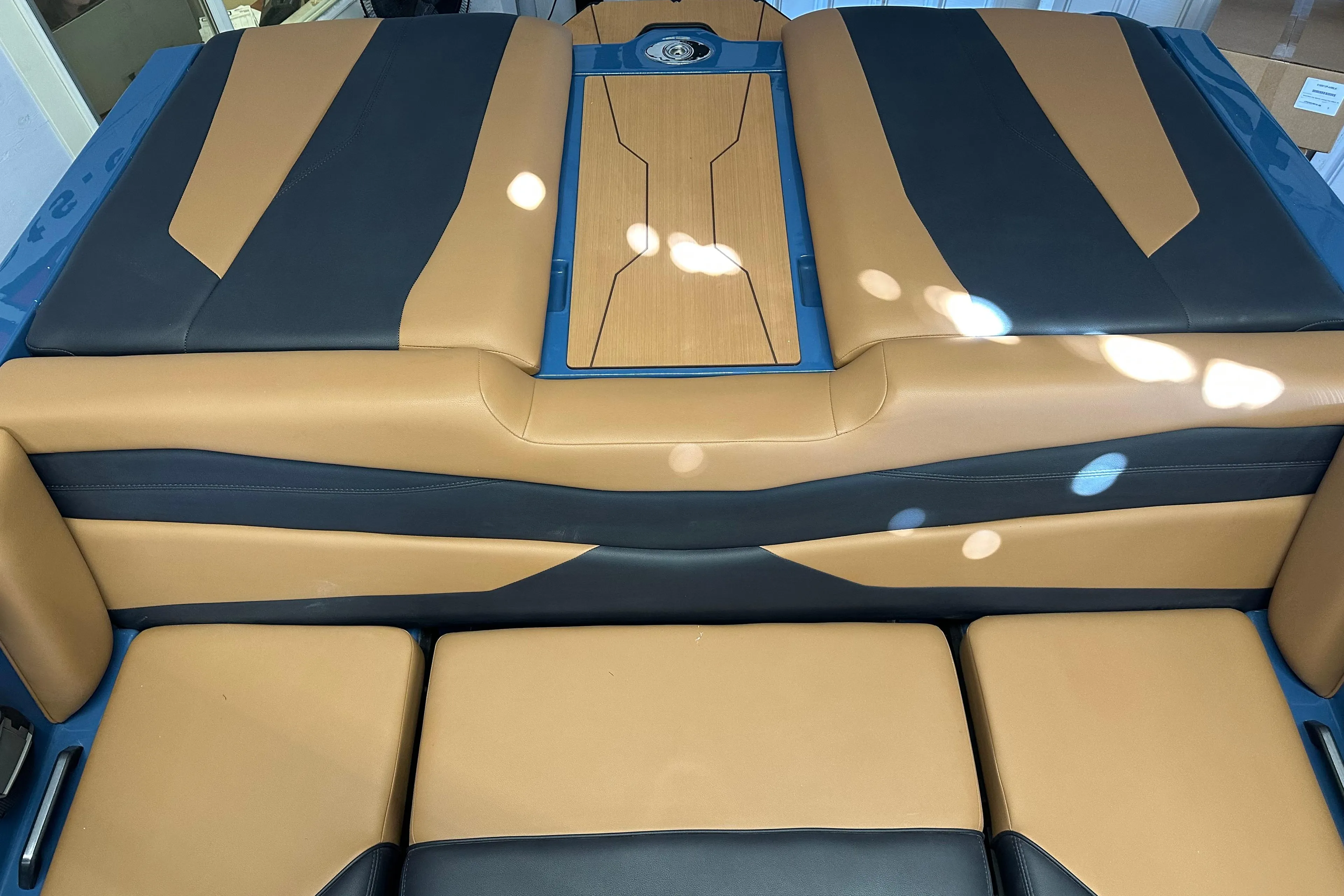 2025 Axis A245 boat interior with tan and black seating design.